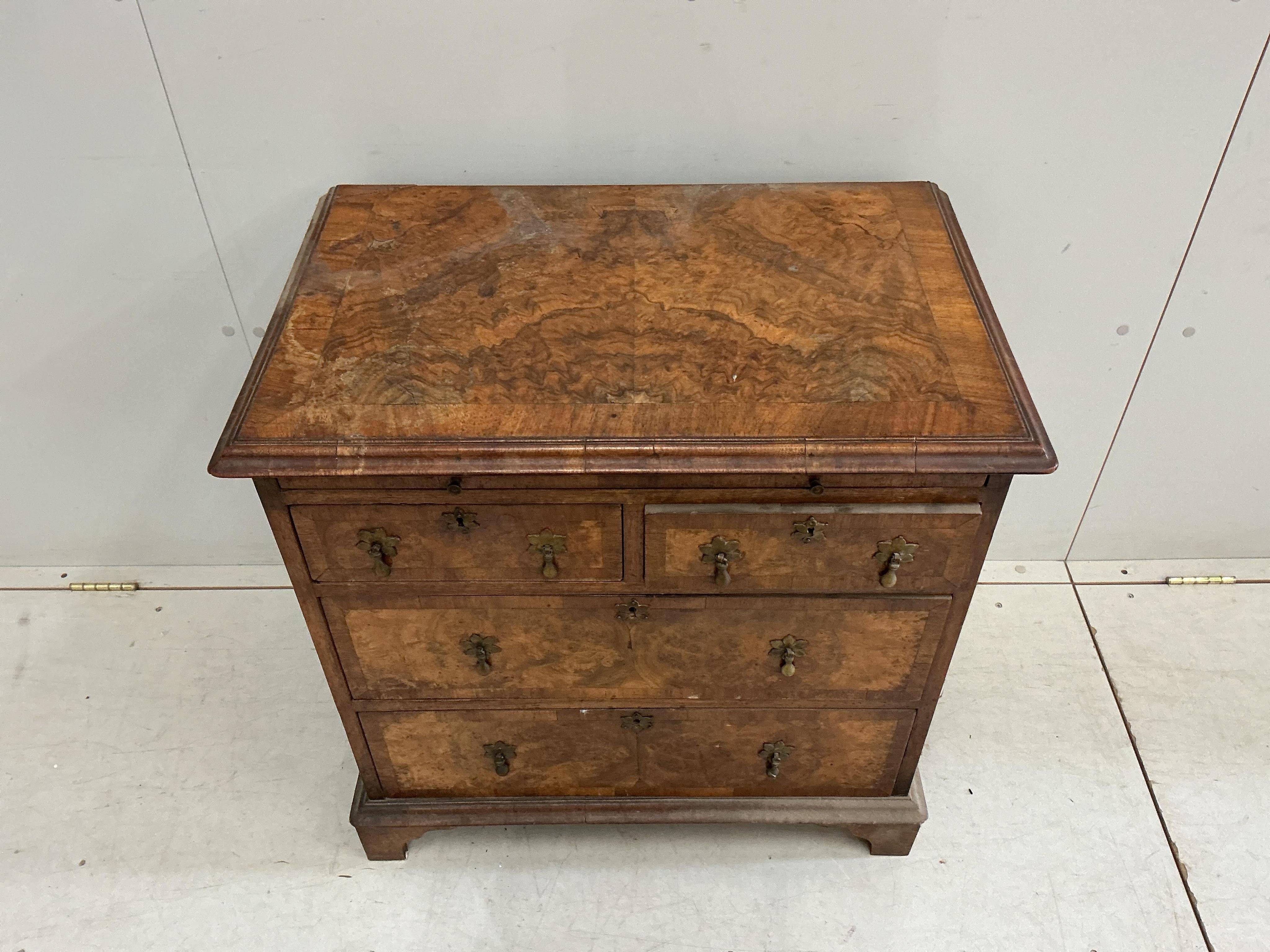 A small Queen Anne Revival crossbanded walnut bachelor’s chest with slide, width 71cm, depth 45cm, height 72cm